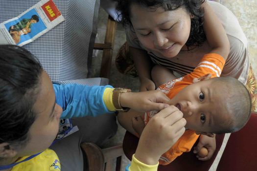 INDONESIA, Jakarta: A child receives Polio immunization in Ciracas, East Jakarta on March 10, 2016 during  National Polio Immunization Week. Indonesian Health Minister Nila Moeloek announced on March 8, 2016 plans to vaccinate 23.7 million babies — from birth to 59 months of age — to keep the world on track toward being polio-free by 2020.