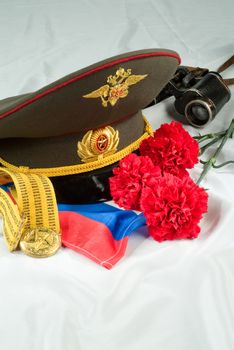 Flowers and army equipment on a studio background