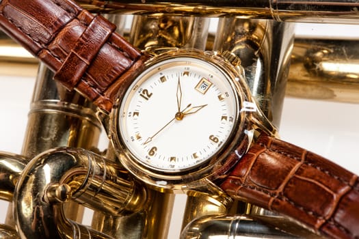 Wristwatch with leather belt on isolated background