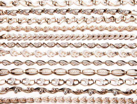 Golden bracelets and violin on isolated white background
