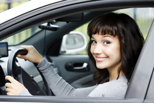 Pretty female driver in a white car