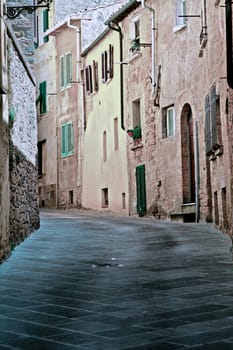 Narrow Alley with Old Buildings in Italian City of Volterra, Vintage Style Toned Picture