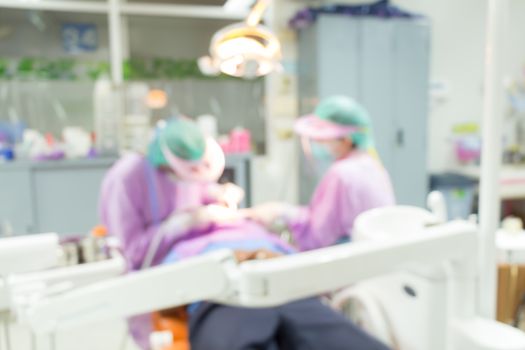 Dentist and Dental assistants in hospital ( blurry dental background ) in thailand