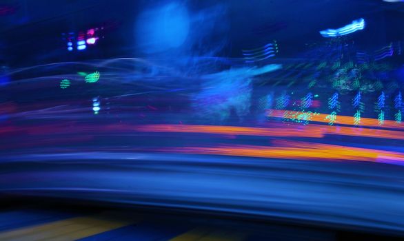 Night colors of the amusement park lights moving, light trails, slow shutter-speed