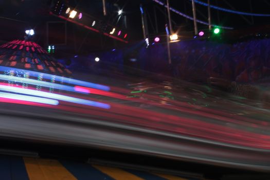 Night colors of the amusement park lights moving, light trails, slow shutter-speed