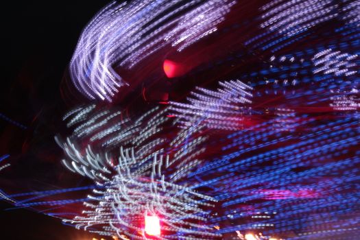 Night colors of the amusement park lights moving, light trails, slow shutter-speed