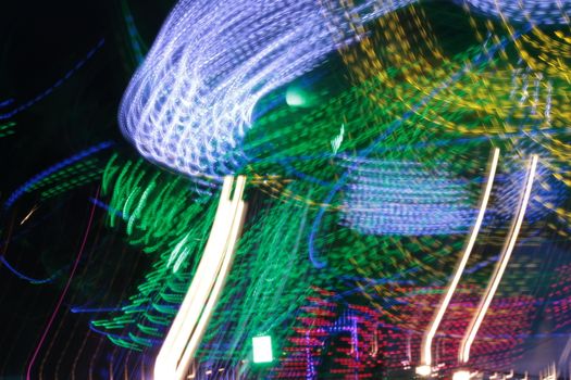 Night colors of the amusement park lights moving, light trails, slow shutter-speed