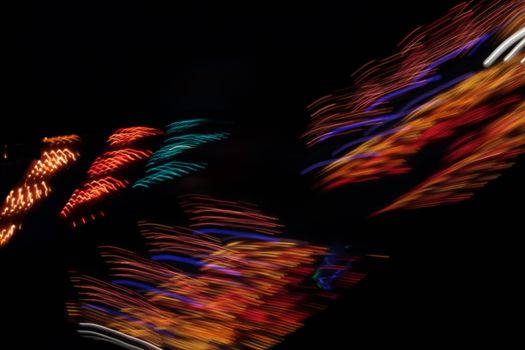 Night colors of the amusement park lights moving, light trails, slow shutter-speed