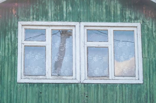 white window in a wooden house green