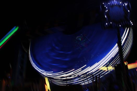 Night colors of the amusement park lights moving, light trails, slow shutter-speed