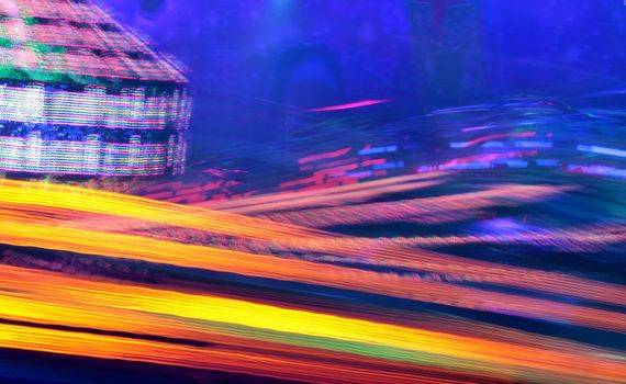 Night colors of the amusement park lights moving, light trails, slow shutter-speed