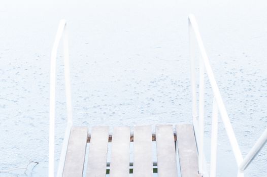 wooden pier, bridge of ice in the water