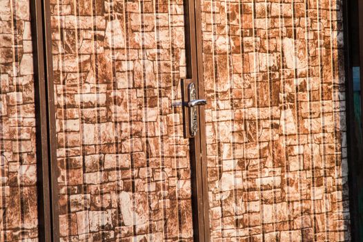 brown camouflage wicket door in the fence