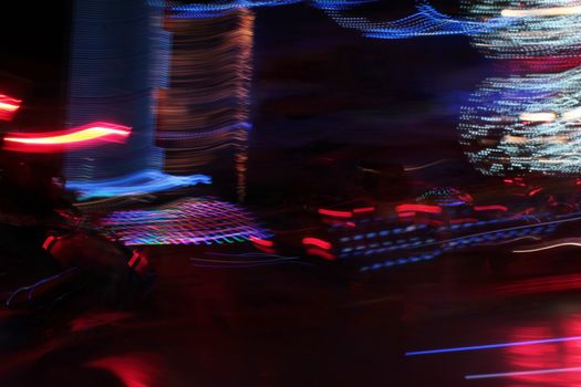 Night colors of the amusement park lights moving, light trails, slow shutter-speed