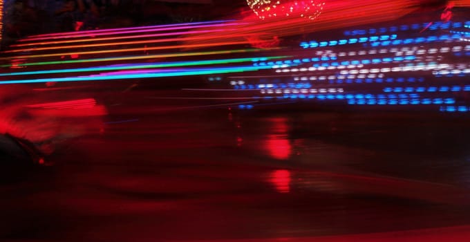 Night colors of the amusement park lights moving, light trails, slow shutter-speed