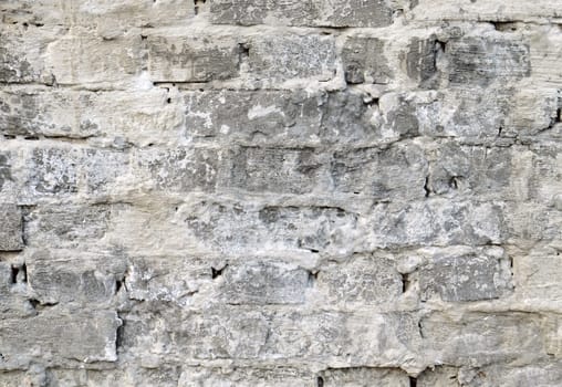 Background of old grey vintage dirty brick wall with peeling plaster, texture.