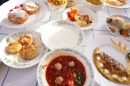 Table lined with plates of soups, cereals and pastries