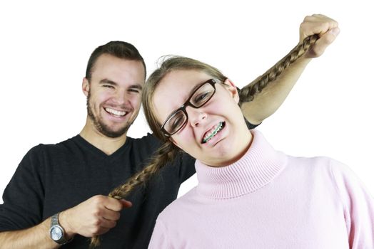 Young Man Pulling Girls Pony-tails