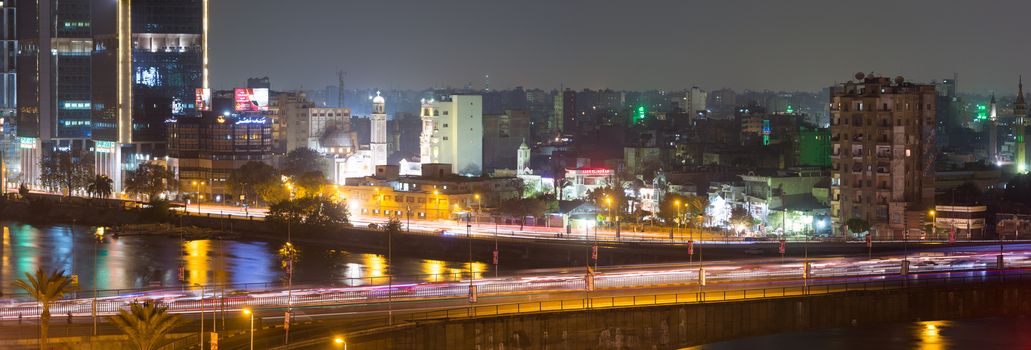 Cairo, Egypt - March 3, 2016: Traffic light trails in central Cairo at night, the 15th May bridge, the Nile river & the Corniche Street.