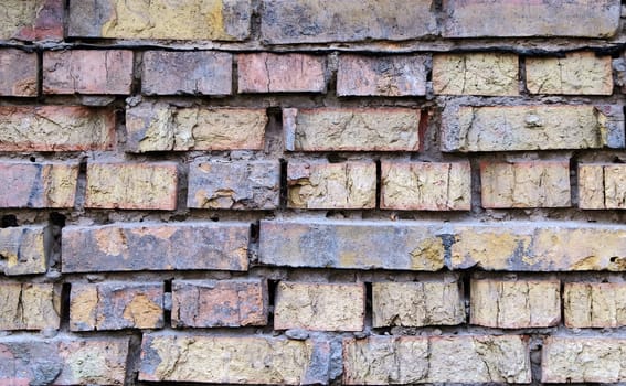 Background of old demege color brick wall with weathered cement solute, texture.