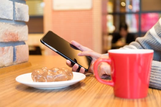 Woman use of the smart phone at cafe