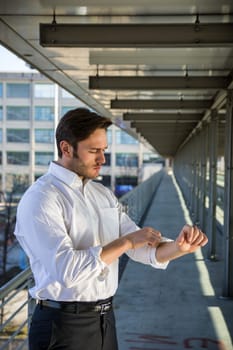 Head and Shoulders Portrait of Stylist Young Man Wearing Suit and Hat Looking to the Side Out Window While Standing on Moving Sidewalk in Building