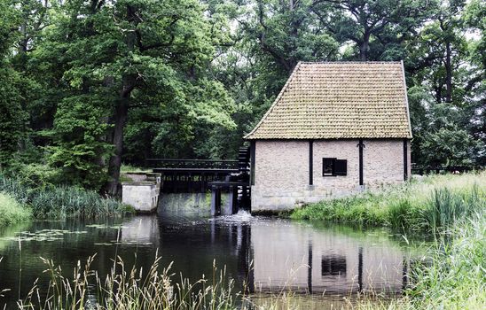 old watermill with bridge in the dutch nature area Twente near the place Delden