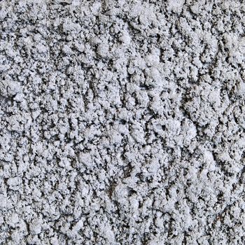 The surface of the gray concrete chips for a background texture.