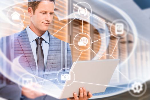 Businessman holding his laptop against abstract turquoise glowing black background