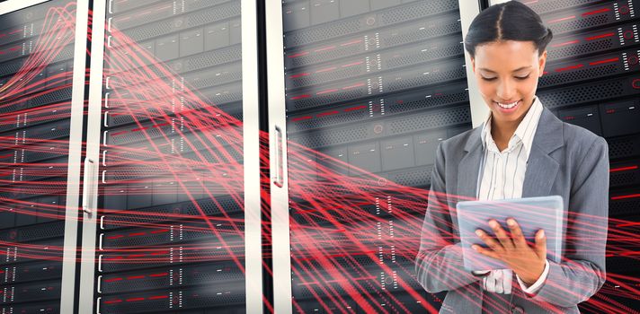 Businesswoman using a tablet with colleagues behind against black background with shiny lines