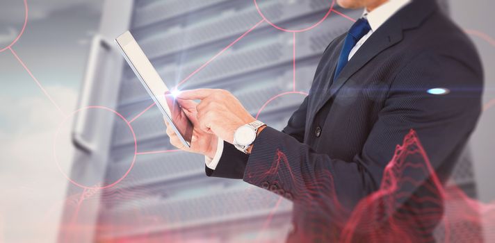 Businessman in suit using digital tablet against abstract blue glowing black background