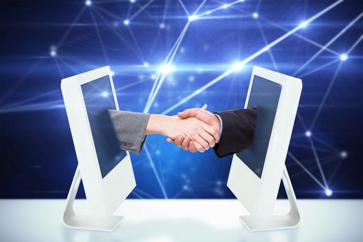 Close up of two businesspeople shaking their hands against lines on glowing background