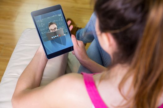 Woman using tablet at home against blue
