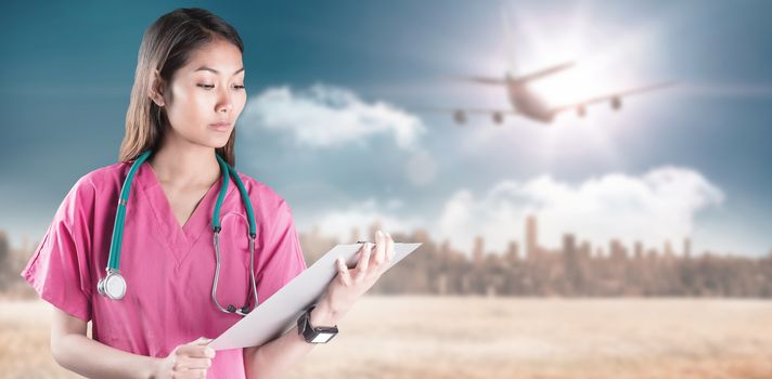 Asian nurse with stethoscope looking at the camera against large city on the horizon