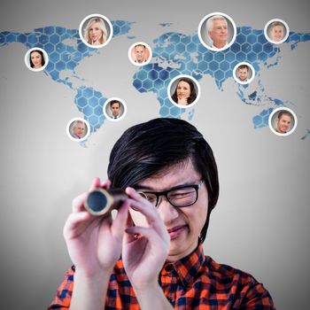 Hipster looking through a telescope against background with hexagons and world map