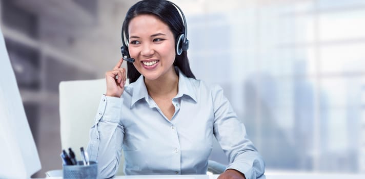 Smiling businesswoman using headset against modern room overlooking city