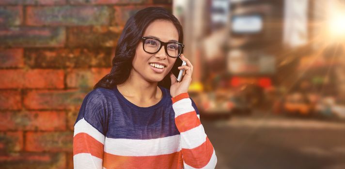 Asian woman on a phone call against wall of a house