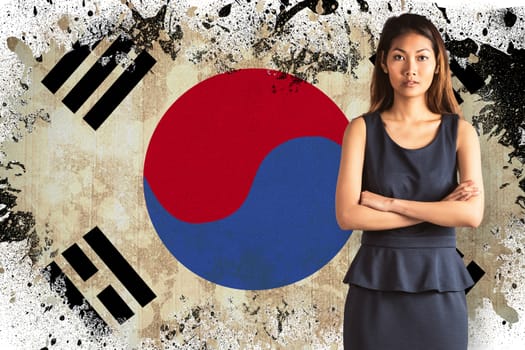 Businesswoman with crossed arms against korea republic flag in grunge effect