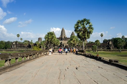 Siem Reap, Cambodia - December 2, 2015: People at the main entrance of Angkor Wat in Siem Reap, Cambodia. The temple has become a symbol of Cambodia