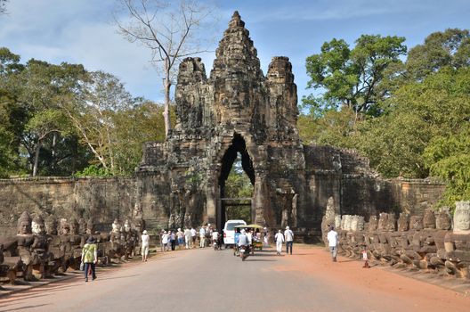Siem Reap, Cambodia - December 4, 2015: Tourists at South gate to Angkor Thom in Siem Reap, Cambodia. The capital of the ancient Khmer empire.
