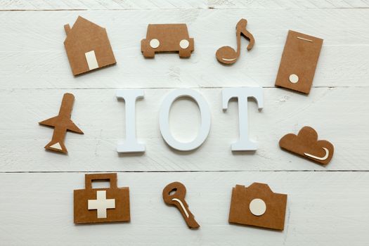 Set of web icons or graphical illustrations cut from cardboard and placed on white wooden background