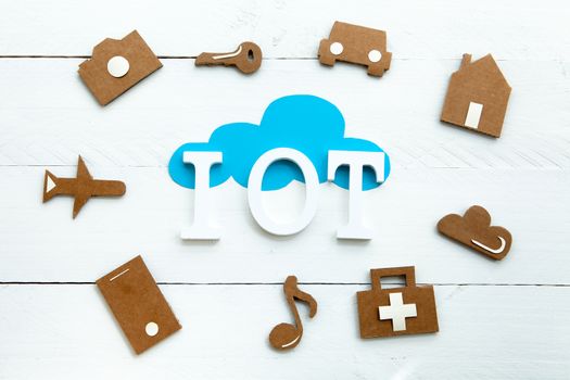 Set of web icons or graphical illustrations cut from cardboard and placed on blue wooden background