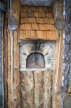 Detail of an outdoor wood-burning oven for baking bread.