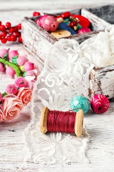 Round colored beads,spools of threads for needlework