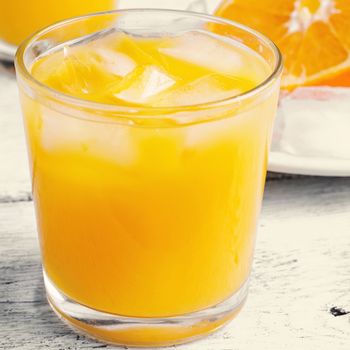 Glass cup with fresh orange juice vitamin.Photo tinted