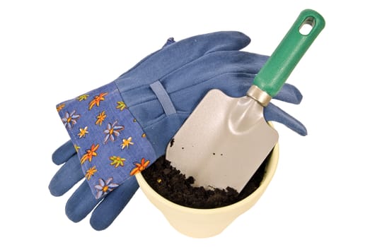 Gardening gloves, trowel, flower pot and soil.  Isolated on white.