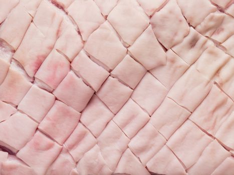 close up of raw uncooked scored pork belly skin food background