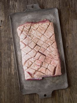 close up of rustic raw uncooked seasoned pork belly