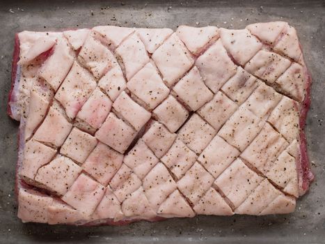 close up of rustic raw uncooked seasoned pork belly