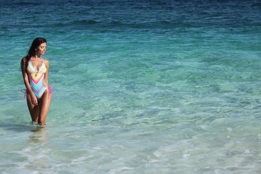 Beautiful woman in swimwear in tropical sea